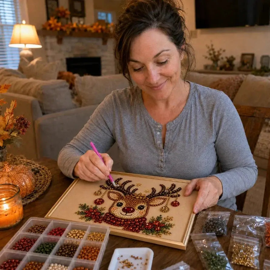 Woman placing beads on a reindeer mosaic with a placement stylus